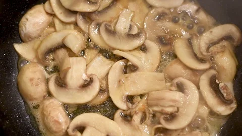 Mushrooms in the process of stewing and frying in a pan in butter Stock-Footage 108205187