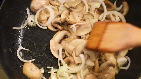 Mushrooms in the process of stewing and frying in a pan in butter Stock-Footage 108205225