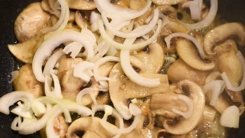 Mushrooms in the process of stewing and frying in a pan in butter Stock-Footage 108205231
