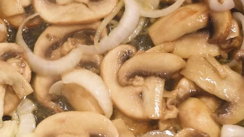 Mushrooms in the process of stewing and frying in a pan in butter Stock-Footage 108205267