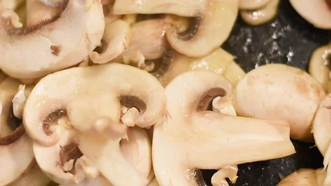 Mushrooms in the process of stewing and frying in a pan in butter Stock-Footage 108205376