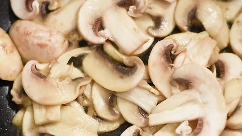 Mushrooms in the process of stewing and frying in a pan in butter Stock-Footage 108205389