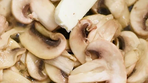 Mushrooms in the process of stewing and frying in a pan in butter Stock-Footage 108205391