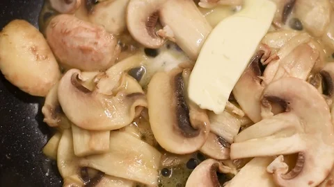Mushrooms in the process of stewing and frying in a pan in butter Stock-Footage 108205433