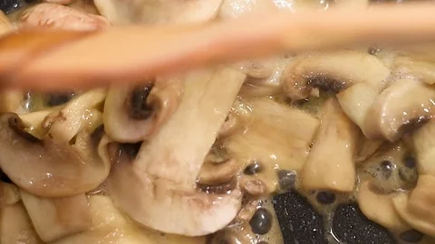 Mushrooms in the process of stewing and frying in a pan in butter Stock-Footage 108205436