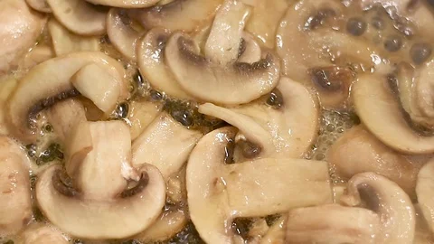 Mushrooms in the process of stewing and frying in a pan in butter Stock-Footage 108205457