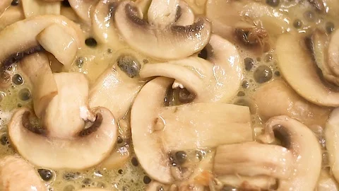 Mushrooms in the process of stewing and frying in a pan in butter Stock-Footage 108205458