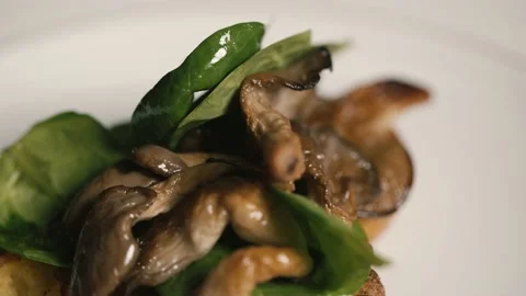 Mushrooms put on spinach Stock Footage 198900703