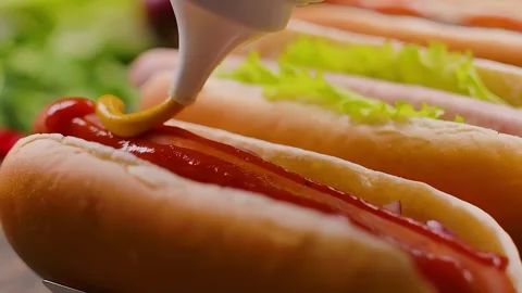 Mushtar being squeezed onto a hot dog sausage Stock Footage 310624347