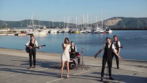 Music band giving a concert in the harbor Stock Footage