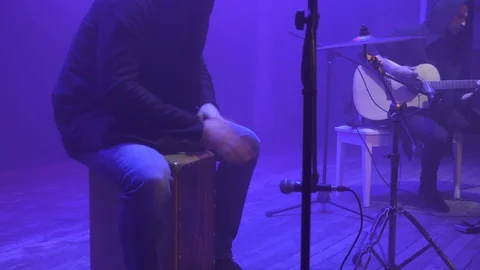 Music band performing on stage in different color light and smoke in background. Video stock 100715802