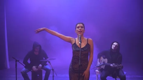 Music band performing on stage in different color light and smoke in background. Video stock 100715846