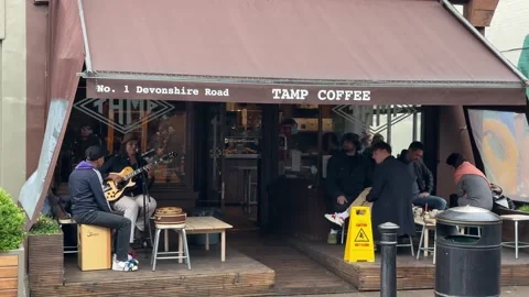 Music band singing outside a cafe Stock Footage 236660153