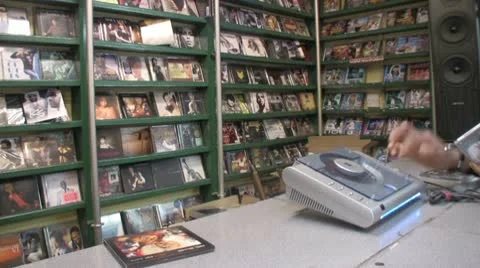 Music CD compact disk stall with a customer playing music Video stock 10750602