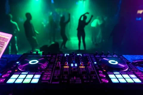 Music controller DJ in the booth on the background of the dance floor Stock Photos