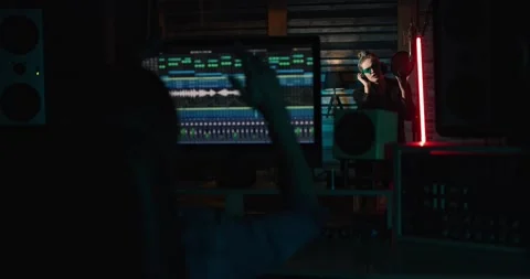 Music Creator Producer looking while Girl Singer Recording Track in Sound Studio Stock Footage 155989152