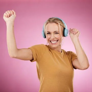 Music, dance and portrait with a woman in studio on a pink background for crazy Stock Photos