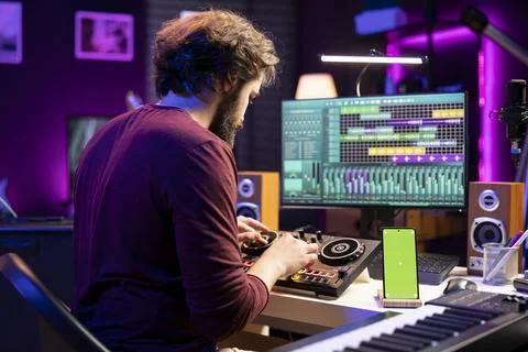 Music engineer twisting pre amp knobs on mixing console in home studio Fotos de archivo