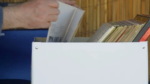 Music fan watches a stack of old 33 rpm vinyl records Stock-Footage 109086787