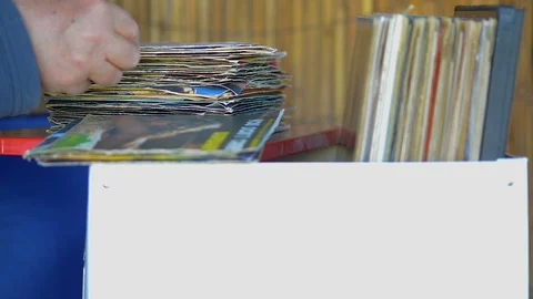 Music fan watches a stack of old 45 rpm vinyl records 動画素材 109086896