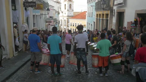A music group plays afro rhythms in a typical street of Salvador, in Brazil Stock Footage 231536424
