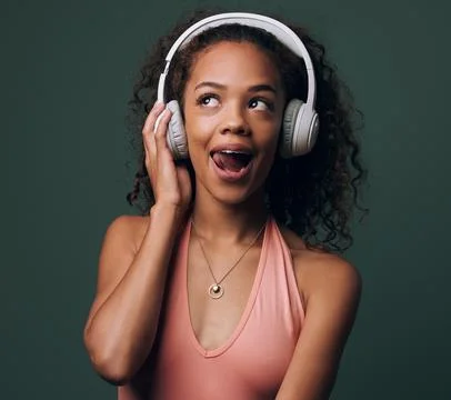Music, headphones and gen z girl in studio for streaming, silly face or audio on Stock Photos