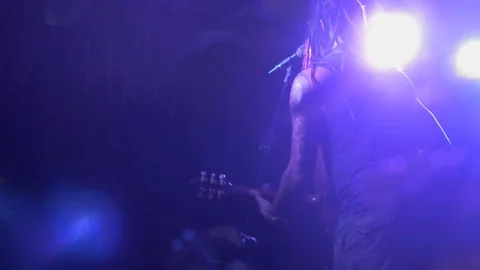 Music performer standing up playing guitar at a live concert event Stock Footage 110798288