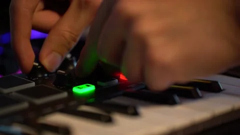 Music producer adjusts knobs for effects and volume on MIDI controller Stock Footage 218097793