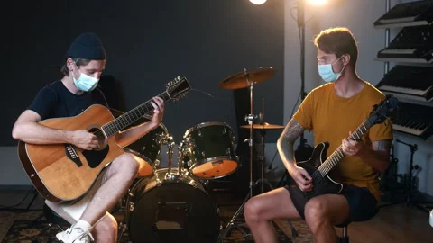 Music production studio. Creative process. Rehearsal of two young Caucasian men Stock Footage 138394077