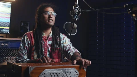 Music production studio. Creative world. Hindi man playing harmonium in the Stock Footage 141462967