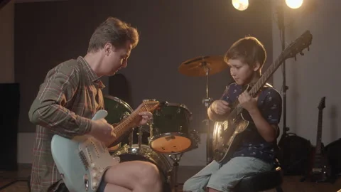 Music production studio. Kid learning about playing guitar and writing songs Stock Footage 138655825