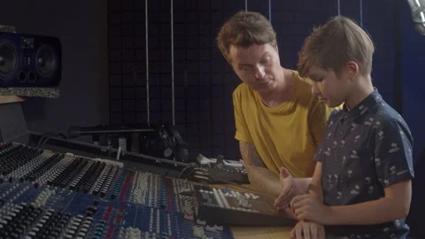 Music production studio. Kid learning about recording methods and the production Stock Footage 140600340