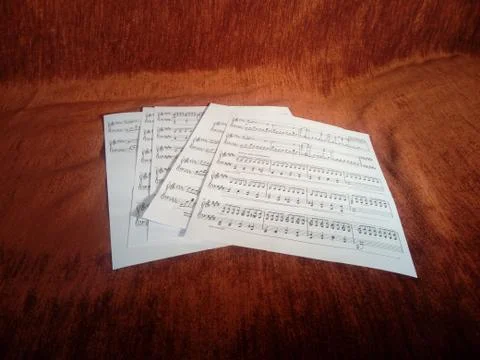 Music sheets on red background Stock Photos