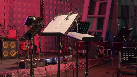 Music sheets on stage with instruments and stands Stock Footage 317099370