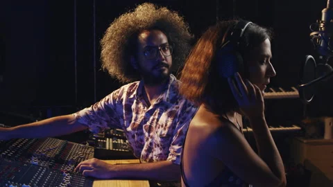Music studio. Creative people. Hispanic man and woman working in the recording Stock Footage 139463956