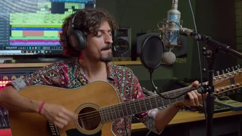 Music studio. Creative process. Musician. Hispanic man is playing guitar and Stock Footage 138524985