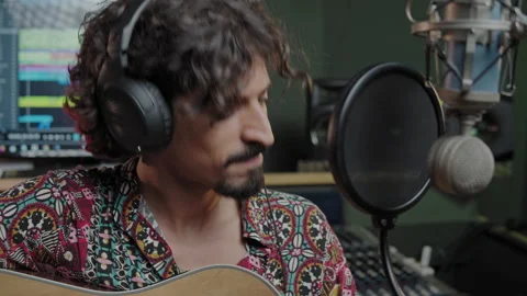 Music studio. Creative process. Musician. Hispanic man is playing guitar and Stock Footage 139414910
