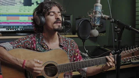 Music studio. Creative process. Musician. Hispanic man is playing guitar and Stock Footage 139896380