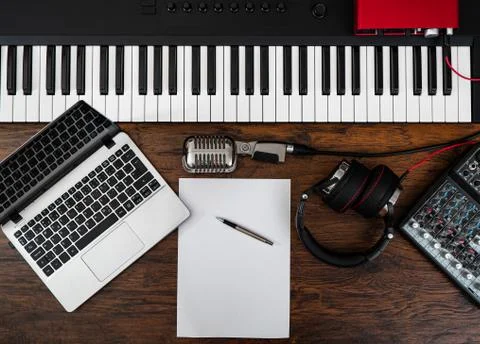 Music studio equipment and white paper with pen. Songwriting concept. Stock Photos