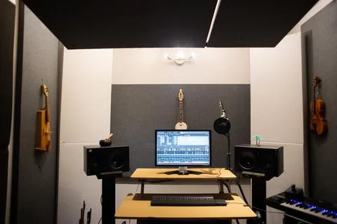 Music studio full of instruments and pc display Stock Photos