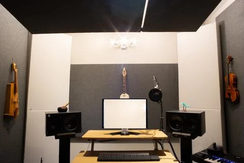 Music studio full of instruments and pc display Stock-Fotos