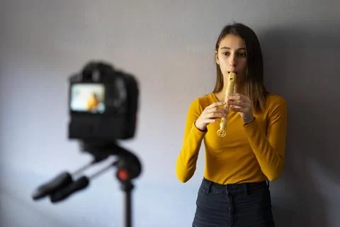 Music teacher making a video tutorial of how to play the flute. Fotos Stock