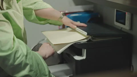 Music teacher organizing. Hands sorting musical sheets in classroom environment Stock Footage 346562448