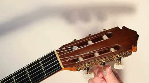 Music teacher tuning students guitar Stock Footage