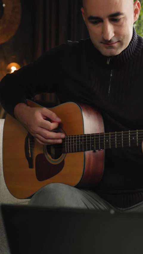 Music therapy and creative hobby, man playing acoustic guitar at home Stock Footage 344143842