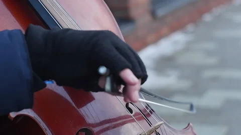 Musical bow moving on strings in man hands on a street Video stock 233514281