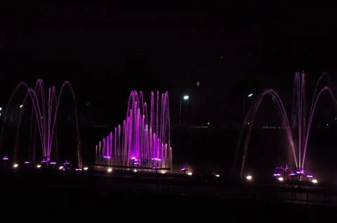 Musical fountain with colorful illuminations at night Stock Photos