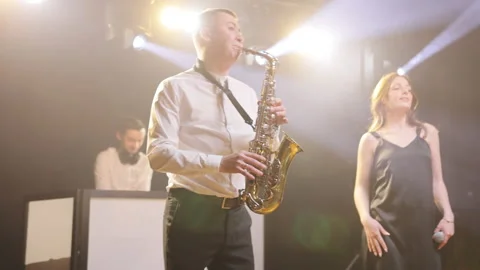 Musical group playing song, performing on concert musician stage with lights. DJ Stock Footage 194761272