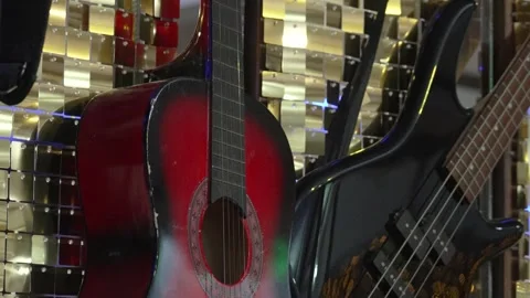 Musical instruments on display in a shop during a sunny afternoon Stock Footage 334545402