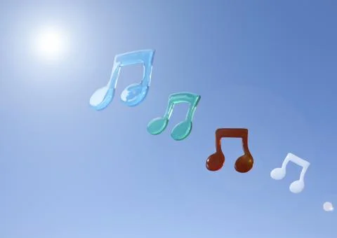 Musical notes floating in blue sky Photos